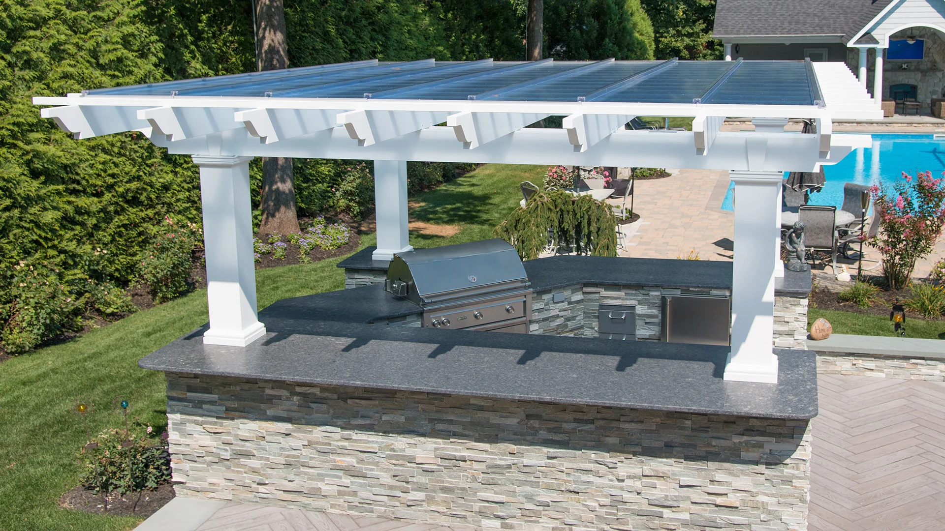 White fiberglass pergola with polycarbonate canopy to protect from rain and snow