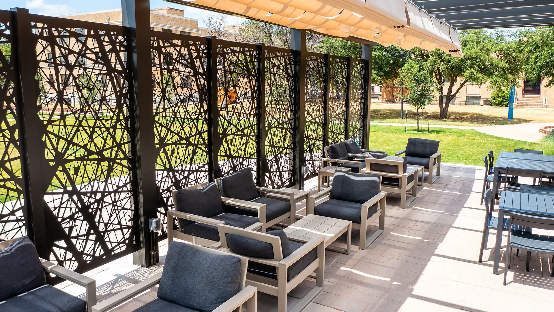 Aluminum pergola with metal panels shading an outdoor space.